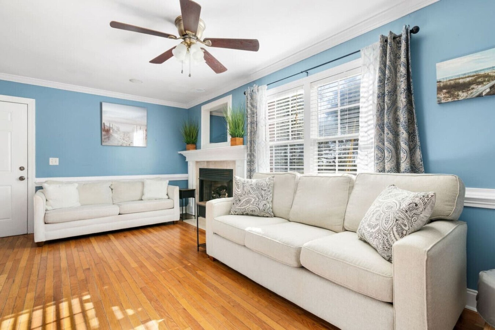 Comfortable living space with fireplace and coastal art